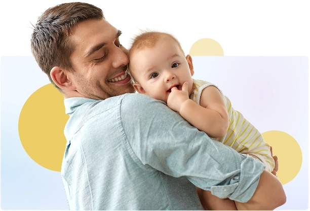 A smiling father holding his infant son