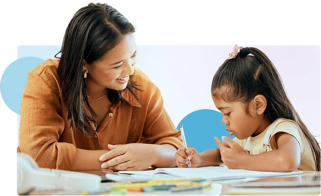 An educator working with a child on a homework activity.